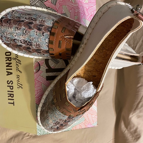 The Sak Shoes - The shoes have a feather print on top with green brown and beige.